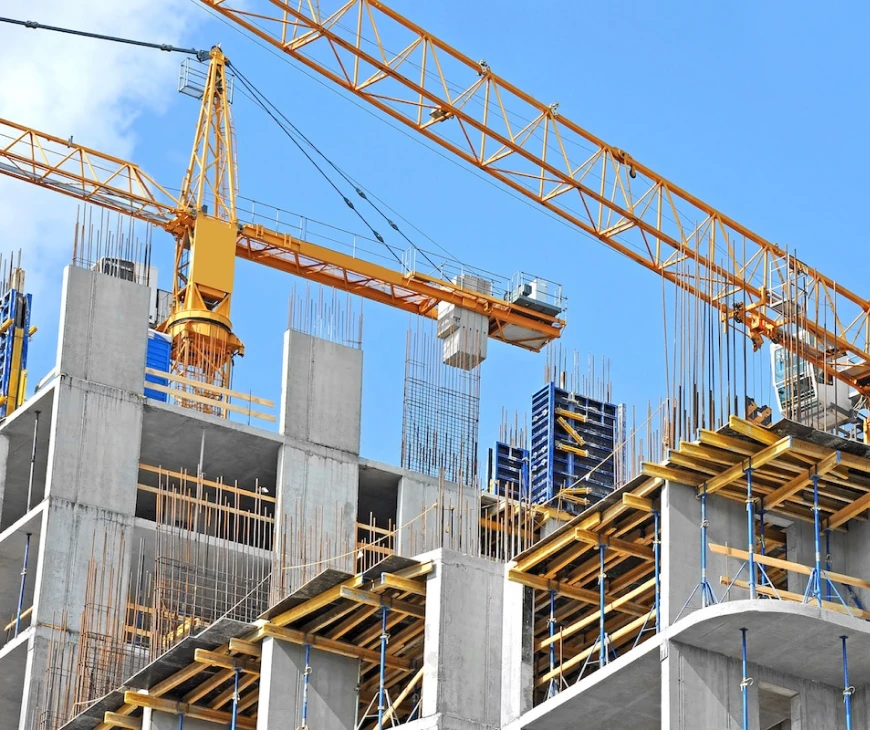 An image of a building with cranes